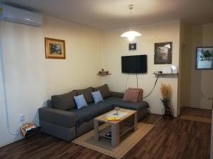 a living room with a couch and a table at Apartman Rosa in Skradin