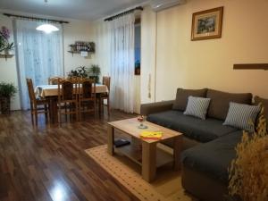 a living room with a couch and a table at Apartman Rosa in Skradin