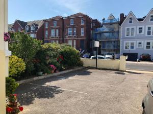 a parking lot next to a street with buildings at Esk Vale Guest House in Portsmouth