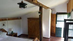 an attic room with a bed and a window at Valchid Guest House in Valchid