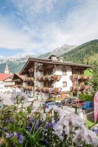 a large building with flowers in front of it at Hotel Angelika in Neustift im Stubaital