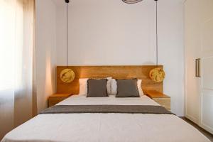 a bedroom with a large bed with two pillows at Phaedrus Living: Seaside Luxury Flat Limnaria 152 in Paphos