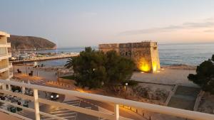 a view from a balcony of a building next to the ocean at Moraira Beach in Moraira