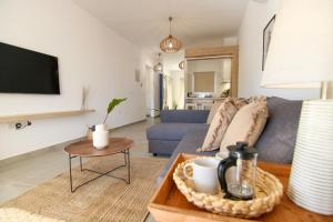 a living room with a couch and a table at Phaedrus Living Seaview Luxury Flat Limnaria 153 in Paphos City