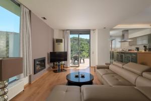 a living room with a couch and a table at Ixian Hilltop Villa in Ialysos