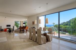 a dining room with a table and chairs with a view at Ixian Hilltop Villa in Ialysos