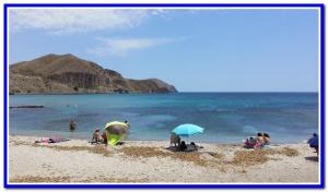 a group of people on a beach with umbrellas at Vera Albacora in Vera