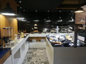 a large kitchen with a buffet at Hotel Vitality Terminus in Kenitra