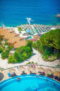 a beach scene with a large blue ocean at Bougainville Bay Hotel in Sarandë
