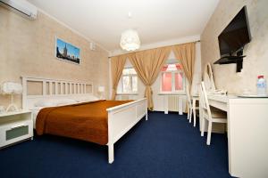 a hotel room with a bed and a desk at Denisovsky Dvorik in Moscow