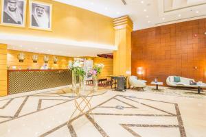 a lobby with a table with flowers on it at Grand Plaza Hotel - Dhabab Riyadh in Riyadh +31 photos