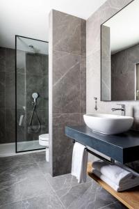 a bathroom with a sink and a mirror at Radisson Blu Hotel, Madrid Prado in Madrid