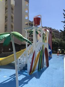 a playground with surfboards and a slide in a pool at Ohtels Belvedere in Salou