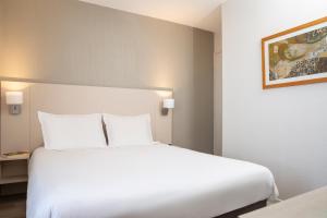 Postel nebo postele na pokoji v ubytování Aparthotel Adagio Access Avignon