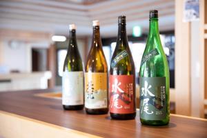 four bottles of wine sitting on a table at Nozawa View Hotel Shimataya in Nozawa Onsen
