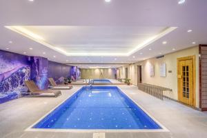 a large swimming pool in a hotel lobby at Grand Plaza Hotel - Dhabab Riyadh in Riyadh