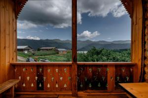 a window in a cabin with a view of the mountains at Guesthouse Elisabeth in Omalo