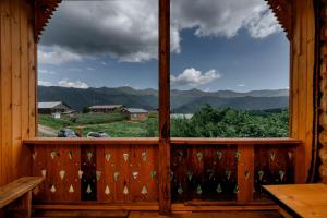 a window in a cabin with a view of the mountains at Guesthouse Elisabeth in Omalo