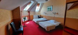 a hotel room with two beds and a television at Pańska Góra in Jaworzno