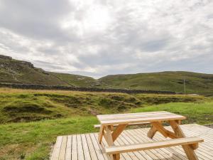 a wooden bench sitting on top of a wooden deck at Deer House in Oldshore