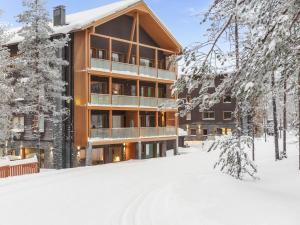 a building in the snow with snow covered trees at Holiday Home Levi hillside by Interhome in Levi