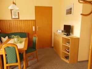 Habitación de hotel con mesa y TV en Ferienwohnung Lohse, en Kurort Altenberg