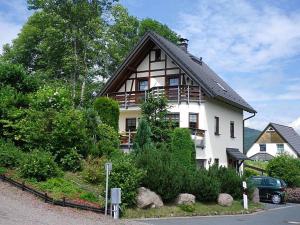 een groot wit huis met een gambrel dak bij Ferienwohnung Lohse in Kurort Altenberg