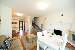 a living room with a white table and a fireplace at Terre dei Consoli Resort e Golf in Monterosi