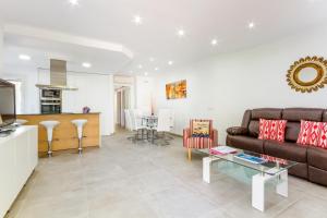 a living room with a couch and a table at Playamar - Private Pool and 150m to Beach in Alcudia