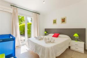 a bedroom with a bed with red and white pillows on it at Playamar - Private Pool and 150m to Beach in Alcudia
