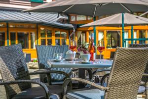 an outdoor table with glasses of wine on it at Corvin Hotel Budapest Corvin Wing in Budapest