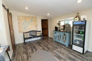 a living room with a refrigerator and a table at Bird's Nest Resort in Put-in-Bay