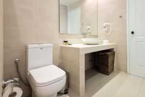 a bathroom with a toilet and a sink at Saint Andrea Seaside Resort - Adults Only in Naousa