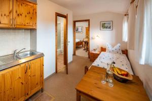 a kitchen with a bed and a table in a room at Landhotel Gut Wildberg mit Sauna in Meißen