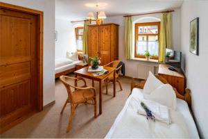 a living room with a couch and a table at Landhotel Gut Wildberg mit Sauna in Meißen