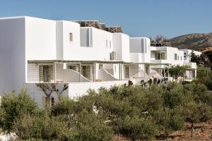 a view of a white house with trees at Saint Andrea Seaside Resort - Adults Only in Naousa