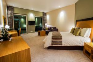 a hotel room with a bed and a living room at Hotel de France in Saint Helier Jersey