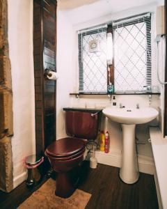 a bathroom with a toilet and a sink at The Rookery Nook and Brontë Parsonage - Haworth in Haworth
