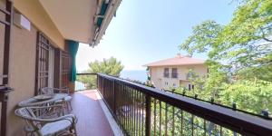 a balcony with chairs and a view of the ocean at Affitto Turistico Via Bonomea 219-1 in Trieste