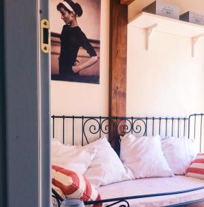 a bedroom with a bed with a poster on the wall at Una casa in Val di Chiana - Tuscan Country House Cetona in Cetona