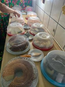 a table with many plates and dishes on it at Pousada Catarinos hostel in Bonito