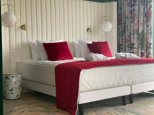 
a white bed sitting in a bedroom next to a white wall at Ego SPA in Birštonas
