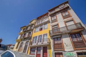 een geel gebouw met balkons aan de zijkant bij São Bento Hill View in Porto