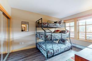 a room with three bunk beds and a window at Copper Mountain Ski Hideaway in Copper Mountain