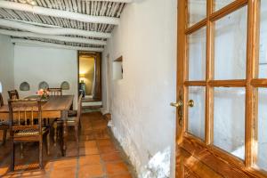 a dining room with a table and chairs and a door at Natte Valleij in Klapmuts