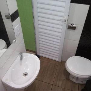 a bathroom with a white sink and a toilet at Pousada Aconchego in Mateiros +19 photos