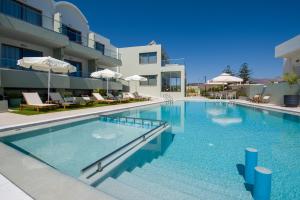 a large swimming pool in front of a building at Incognito Creta Luxury Suites and More in Kolymvari