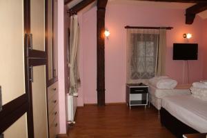 a bedroom with two beds and a television in it at Konak Hotel Tuzla in Tuzla