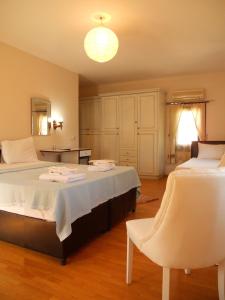 A bed or beds in a room at Konak Hotel Tuzla