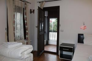 A bed or beds in a room at Konak Hotel Tuzla